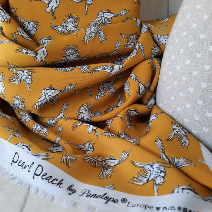 Dressmaking 100% Polyester
Pearl peach by Penelope- Bird Print 144cm 142g/m2 - Ochre