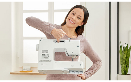 Woman smiling and holding the Brother SH40 electronic sewing machine