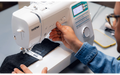 Person sewing denim fabric on the Brother Innov-is A65 sewing machine