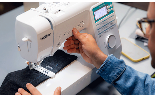 Person sewing denim fabric on the Brother Innov-is A65 sewing machine