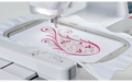 Brother Innov-is V3LE embroidering a decorative swirl design on white fabric
