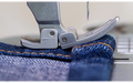 Brother PQ1600S flexible presser foot sewing a layered denim seam