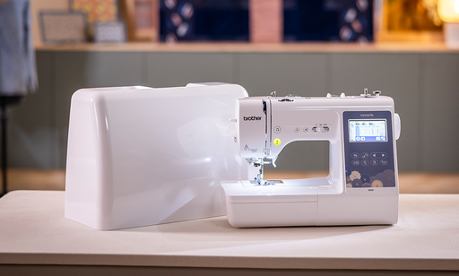 Brother Innov-is M380 sewing machine beside its hard case