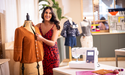 Brother Innov-is M380 beside a finished orange blouse on a dress form