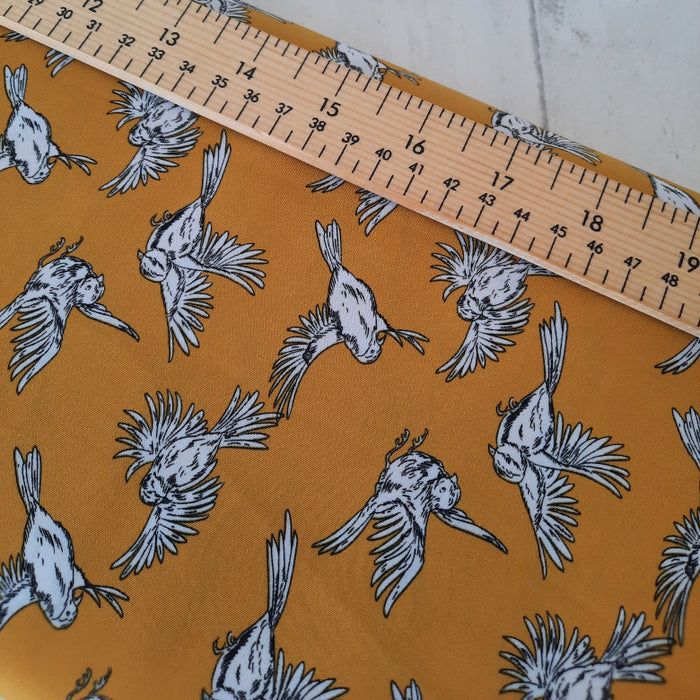 Dressmaking 100% Polyester 
Pearl peach by Penelope- Bird Print 144cm 142g/m2 - Ochre